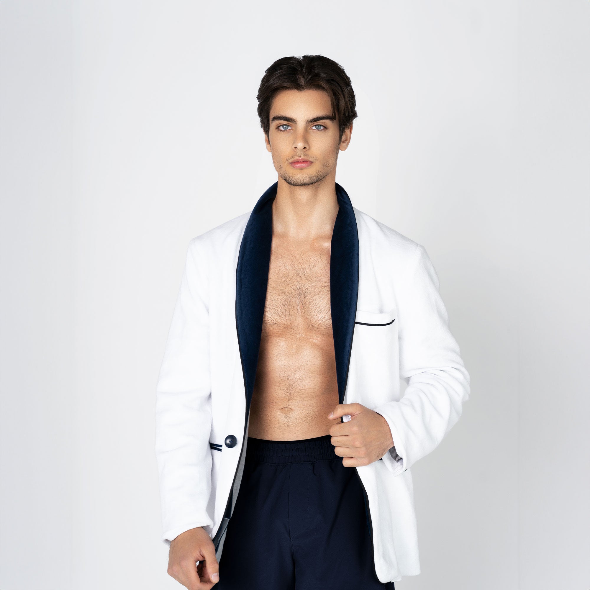 A white beach tuxedo bath robe with navy blue lapels and trim, featuring a single button closure and functional pockets. For yacht parties on boats and summers at the beach
