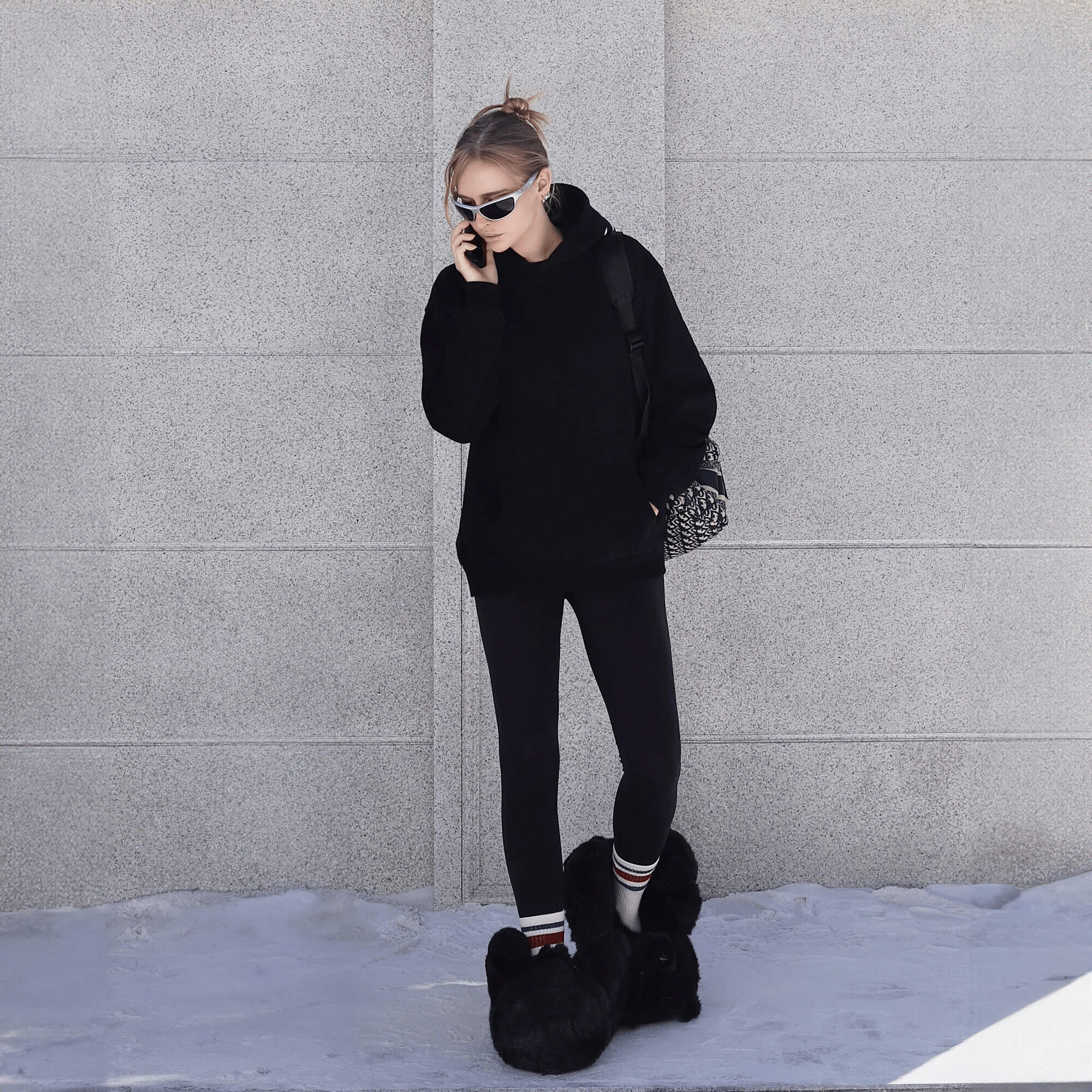 girl wearing black hoodie and teddy bear slippers