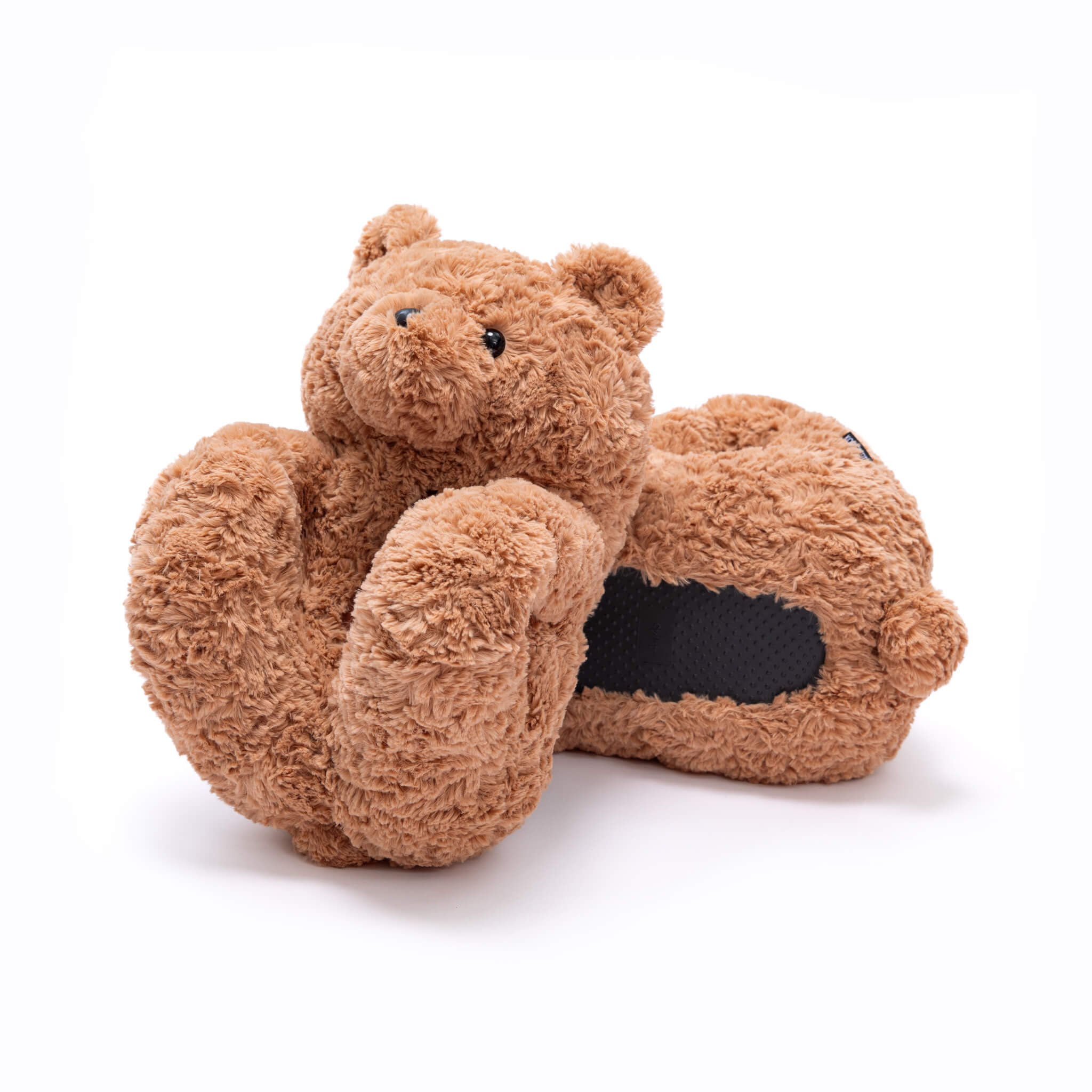 Pair of brown beige curly swirly teddy bear slippers shoes on a white background