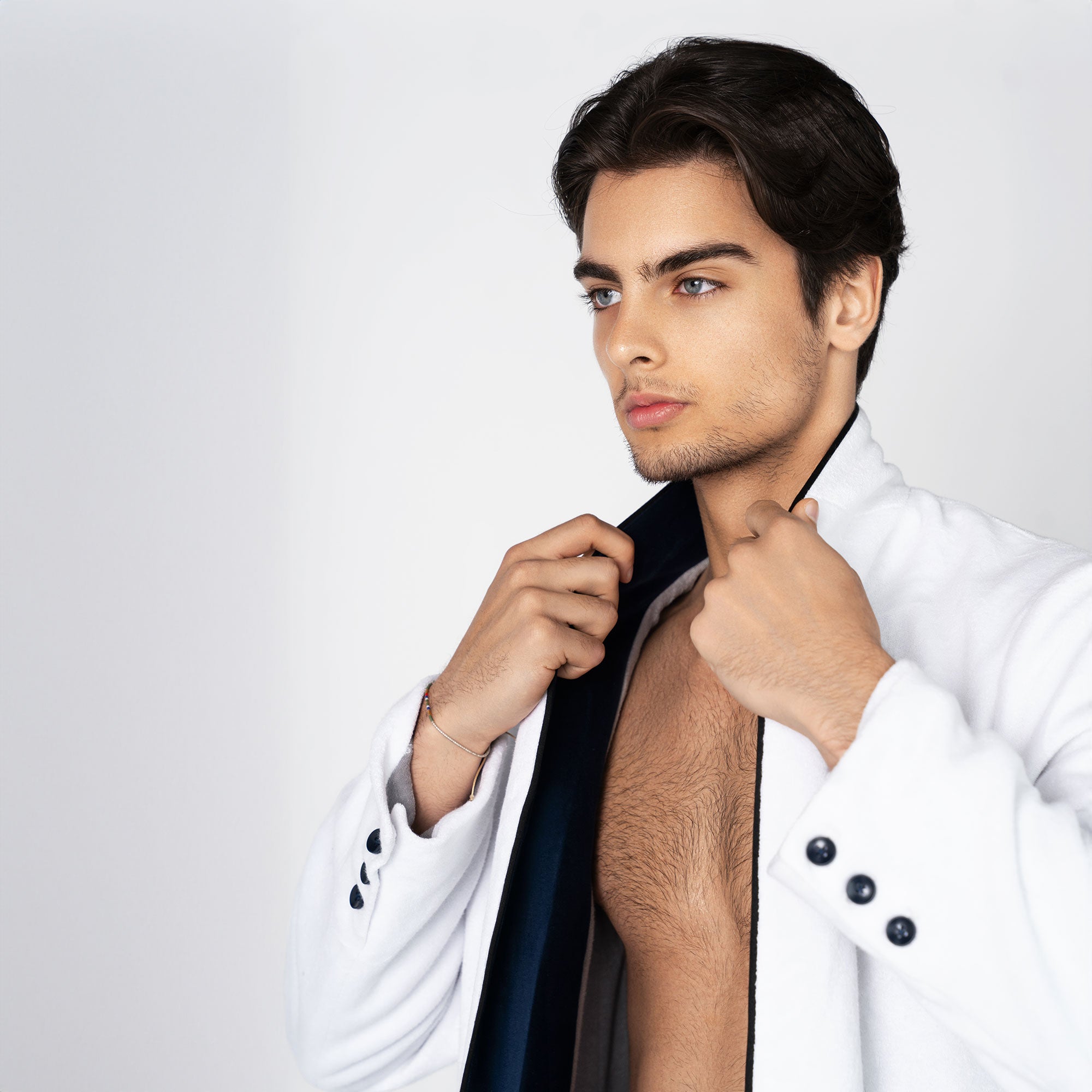 A white beach tuxedo bath robe with navy blue lapels and trim, featuring a single button closure and functional pockets. For yacht parties on boats and summers at the beach