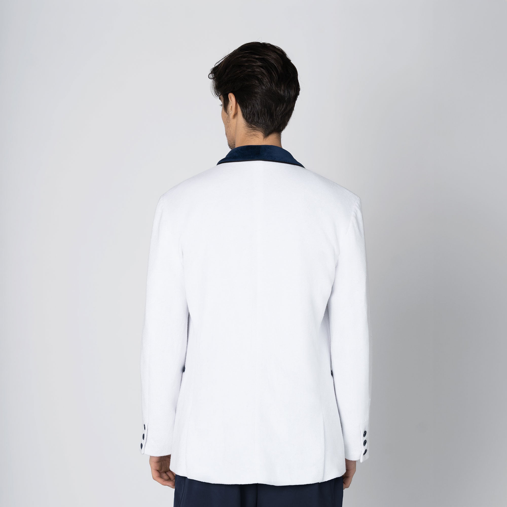A white beach tuxedo bath robe with navy blue lapels and trim, featuring a single button closure and functional pockets. For yacht parties on boats and summers at the beach
