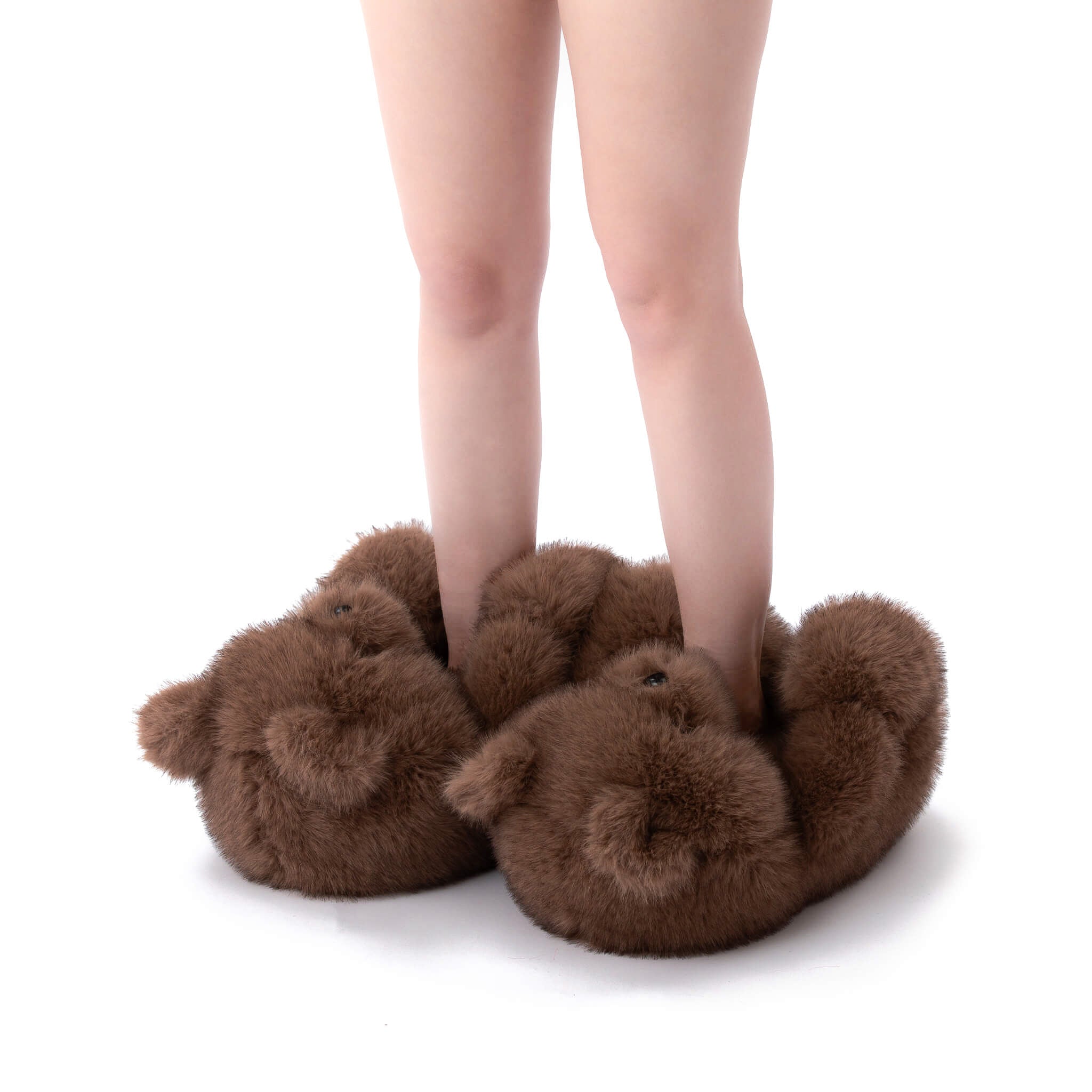 Brown chocolate fuzzy slippers shoes worn by a person on a white background